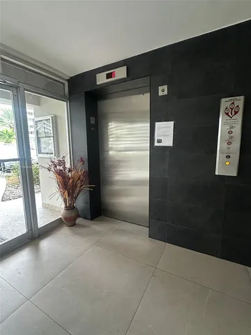 a view of an empty room and a bathroom