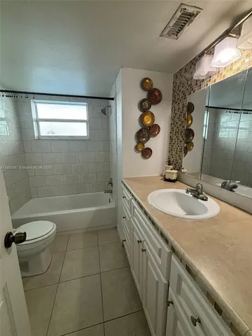 a bathroom with a toilet bathtub and shower