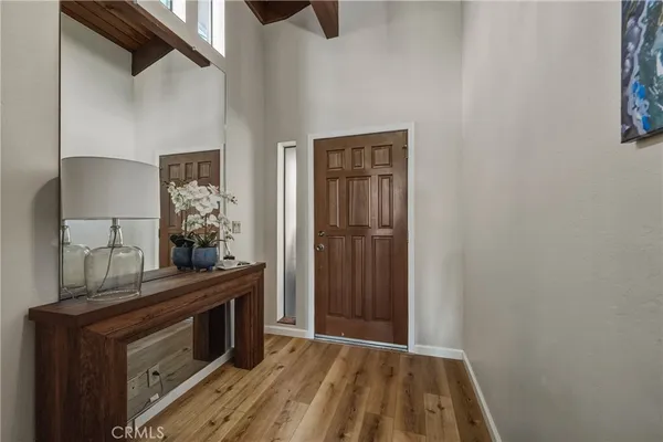 a living room with lots of furniture and kitchen view