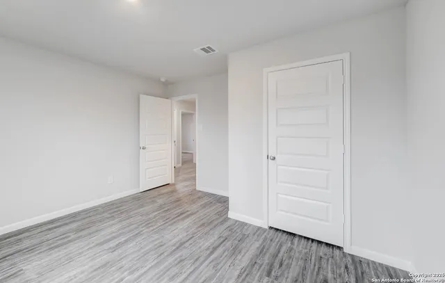 a view of an empty room and wooden floor