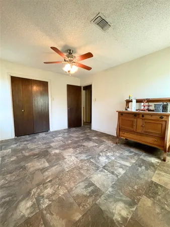 a view of a livingroom with a ceiling fan and window
