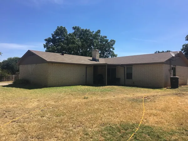 a house with trees in the background