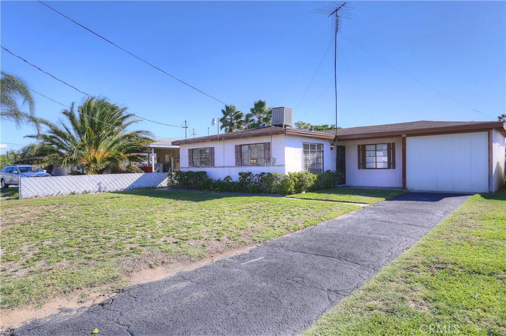 423 Allen Street Rialto, CA 92376 - Photo 1 of 1 a front view of house with yard and palm tree