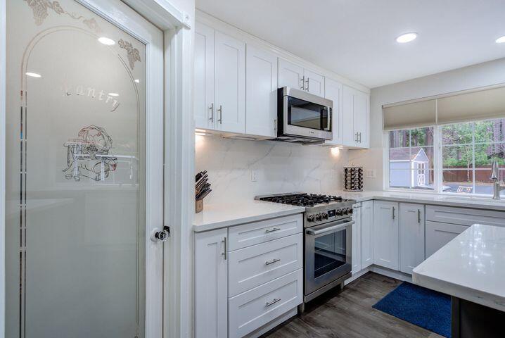 37105 Sapphire Road Burney, CA 96013 - Photo 11 of 39 a kitchen with stainless steel appliances granite countertop white cabinets and window