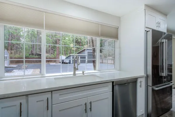 a kitchen with appliances cabinets and a sink