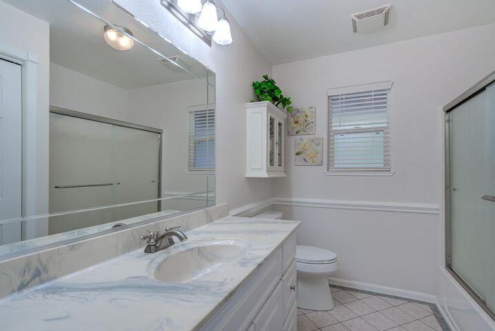 37105 Sapphire Road Burney, CA 96013 - Photo 17 of 39 a bathroom with a granite countertop toilet a sink and a mirror