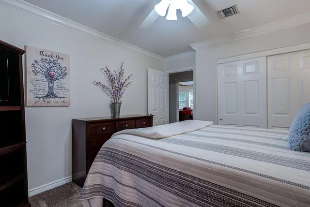 a bedroom with a large bed and a chandelier