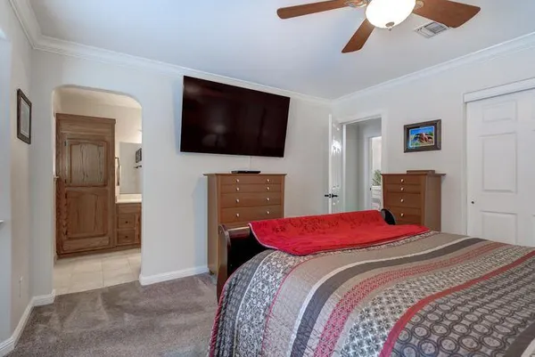 a bedroom with a bed and a television