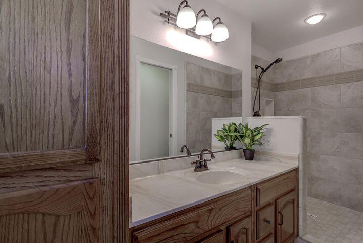 37105 Sapphire Road Burney, CA 96013 - Photo 25 of 39 a bathroom with a granite countertop sink and a mirror