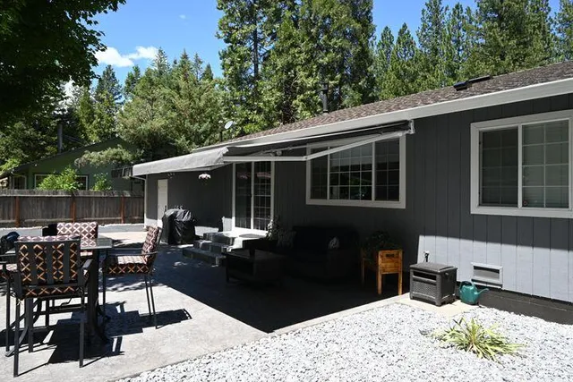 a front view of a house with outdoor seating