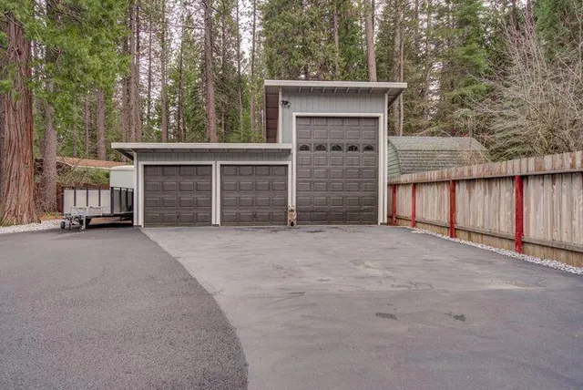 a view of a house with a garage and yard