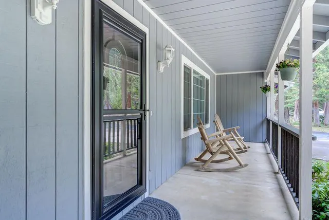 a view of chair in the balcony with wooden floor