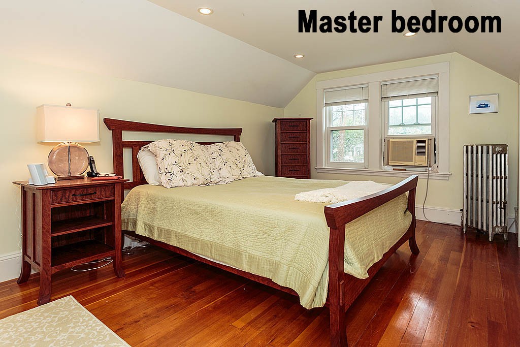 306 Appleton Street Arlington, MA 02476 - Photo 13 of 24 a bedroom with a bed and wooden floor
