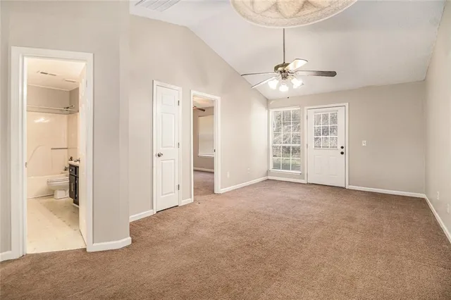 an empty room with fan and entrance