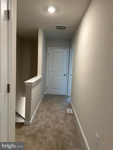 a view of a hallway with bathroom