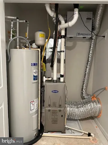 a view of a house with a backyard and a tree