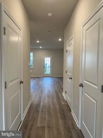 a view of hallway with wooden floor