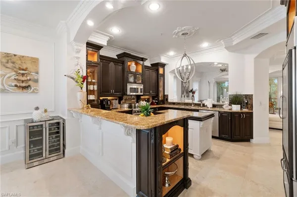 a kitchen with stainless steel appliances granite countertop a sink a stove and a refrigerator