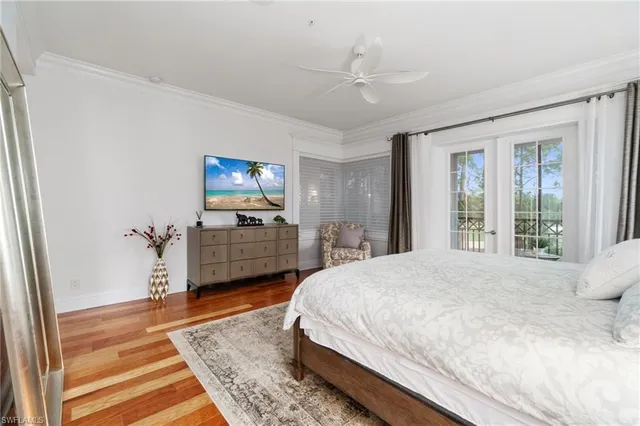 a spacious bedroom with a bed and wooden floor