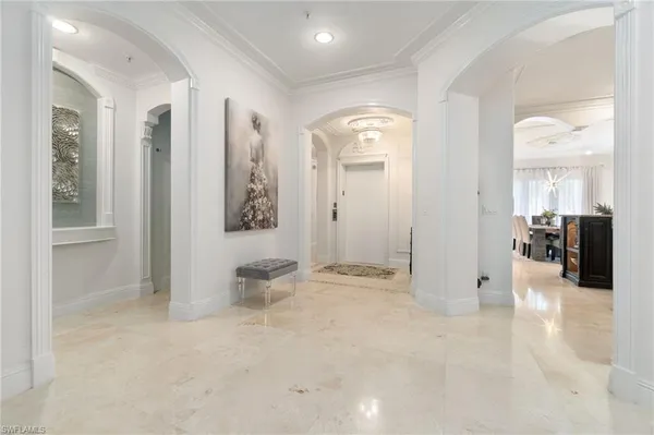 a view of a hallway with wooden floor and furniture