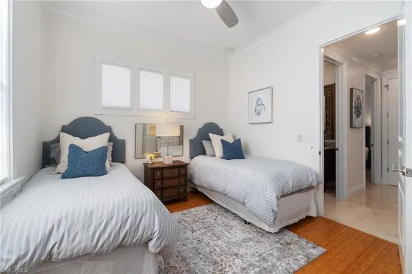 a bedroom with two beds and a large window