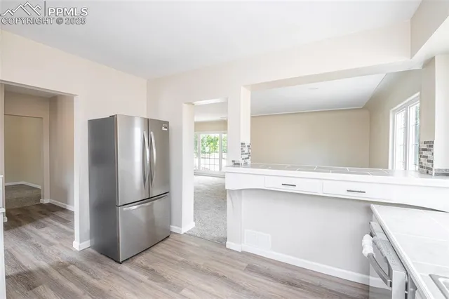 a kitchen with granite countertop stainless steel appliances and wooden cabinets