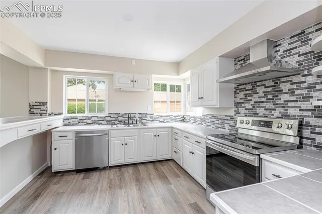 a bathroom with a granite countertop sink and a window