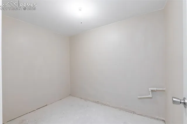 a backyard of a house with plants and large trees