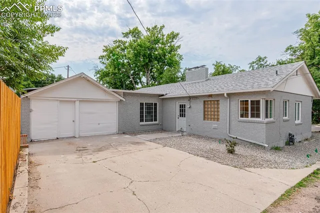 a view of a livingroom with a fireplace and window