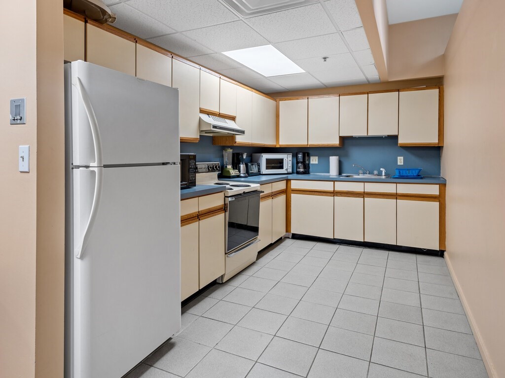 10 Linwood Street, Unit 214 Malden, MA 02148 - Photo 20 of 37 a kitchen with stainless steel appliances a refrigerator sink and cabinets