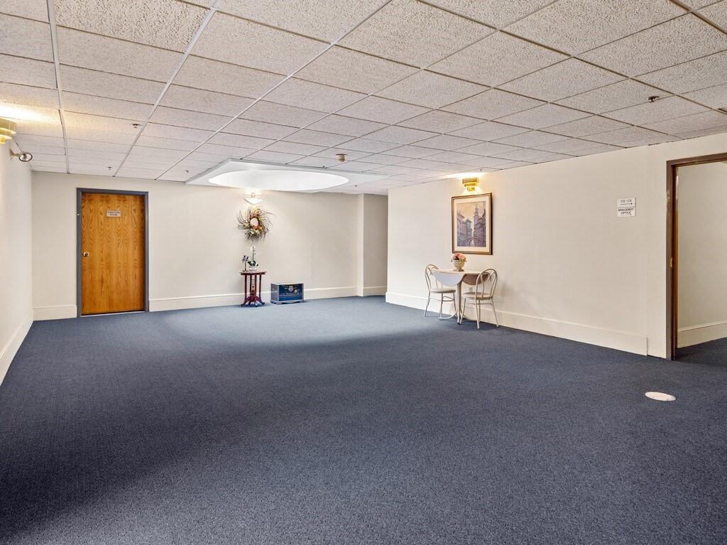 10 Linwood Street, Unit 214 Malden, MA 02148 - Photo 22 of 37 a view of a livingroom with furniture and a ceiling fan