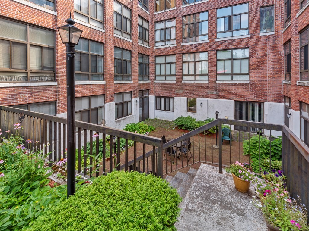 10 Linwood Street, Unit 214 Malden, MA 02148 - Photo 25 of 37 a view of a brick building next to a yard