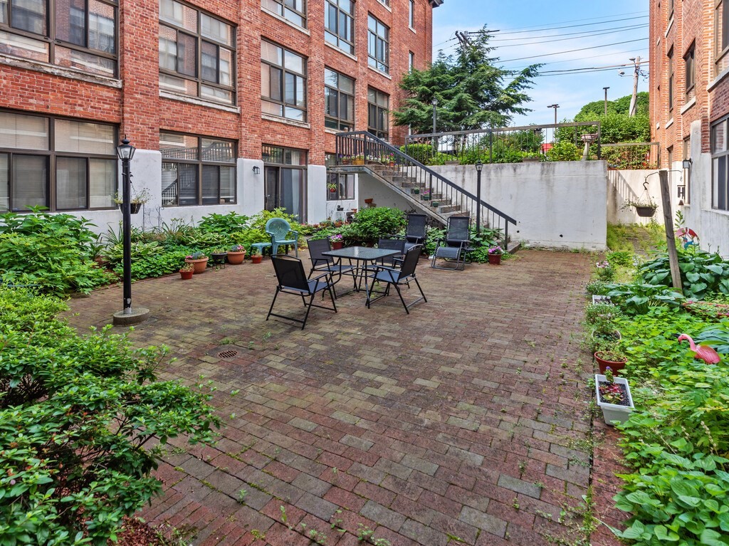 10 Linwood Street, Unit 214 Malden, MA 02148 - Photo 27 of 37 a view of a patio with a table and chairs