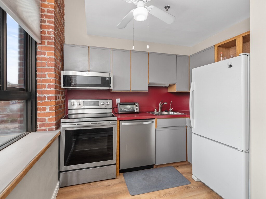 10 Linwood Street, Unit 214 Malden, MA 02148 - Photo 4 of 37 a kitchen with a refrigerator sink and cabinets