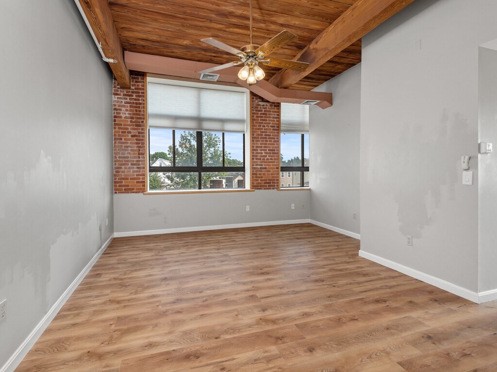 10 Linwood Street, Unit 214 Malden, MA 02148 - Photo 8 of 37 an empty room with wooden floor and windows
