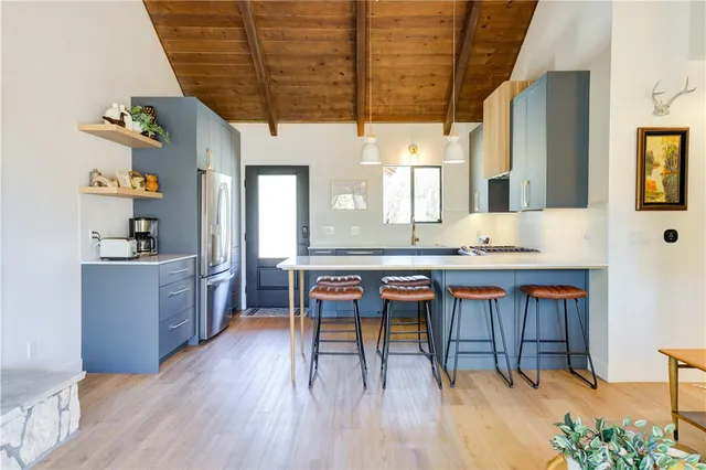 a living room with furniture and a fireplace with wooden floor