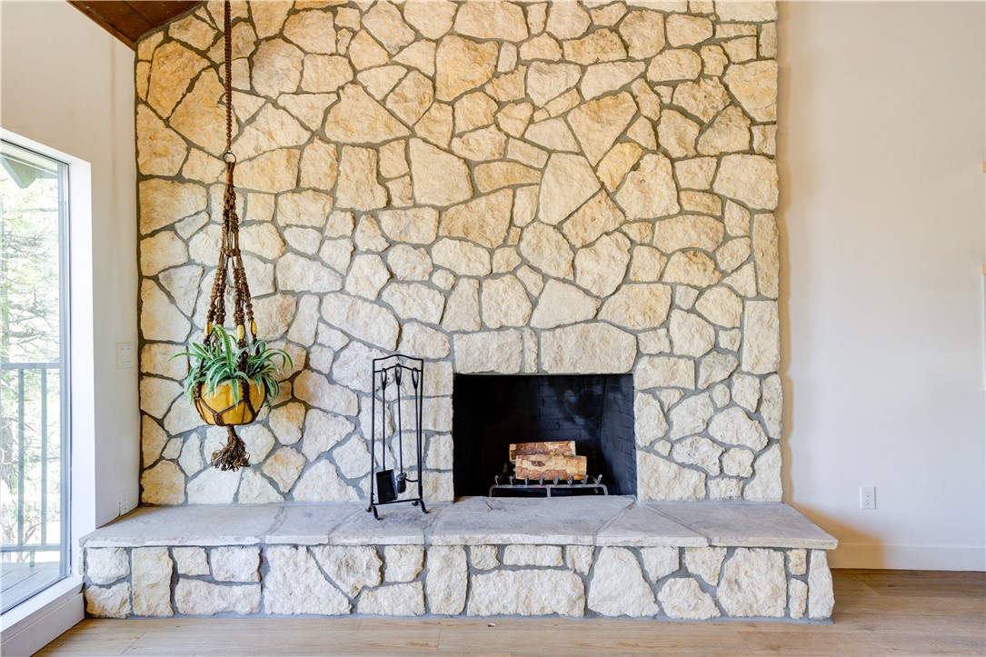 1032 Grass Valley Road Lake Arrowhead, CA 92352 - Photo 13 of 48 a fireplace with a rug and a wall painting
