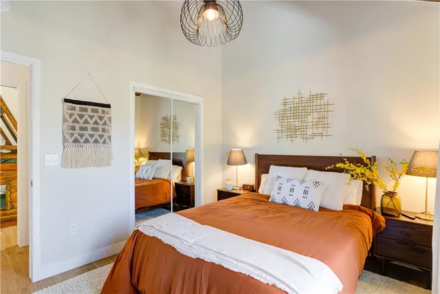 a bedroom with a bed and a painting on the wall