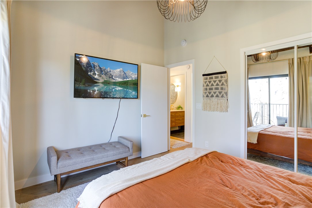 1032 Grass Valley Road Lake Arrowhead, CA 92352 - Photo 22 of 48 a bedroom with a bed and a painting on the wall