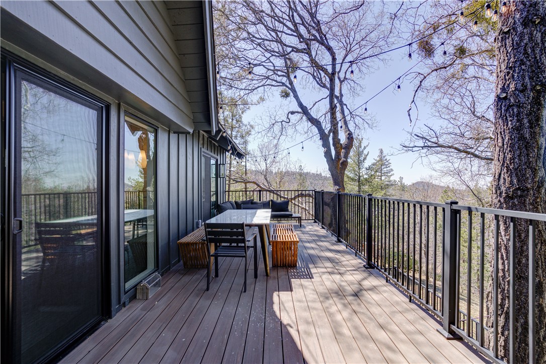 1032 Grass Valley Road Lake Arrowhead, CA 92352 - Photo 23 of 48 a view of balcony with chairs and wooden fence