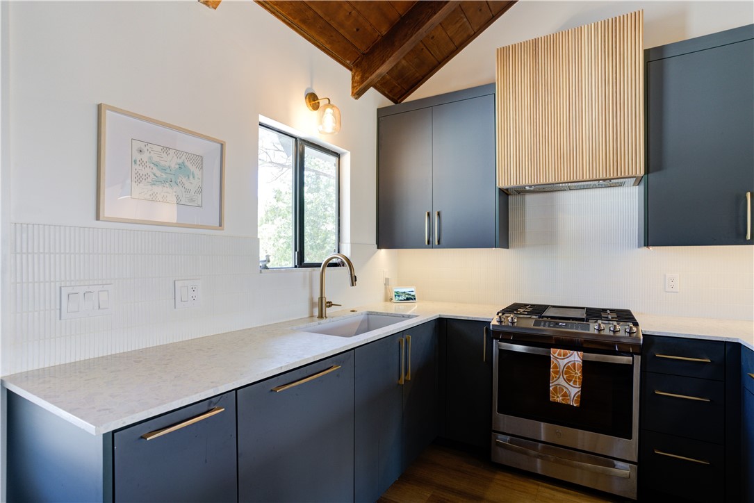 1032 Grass Valley Road Lake Arrowhead, CA 92352 - Photo 3 of 48 a kitchen with a sink a stove and cabinets