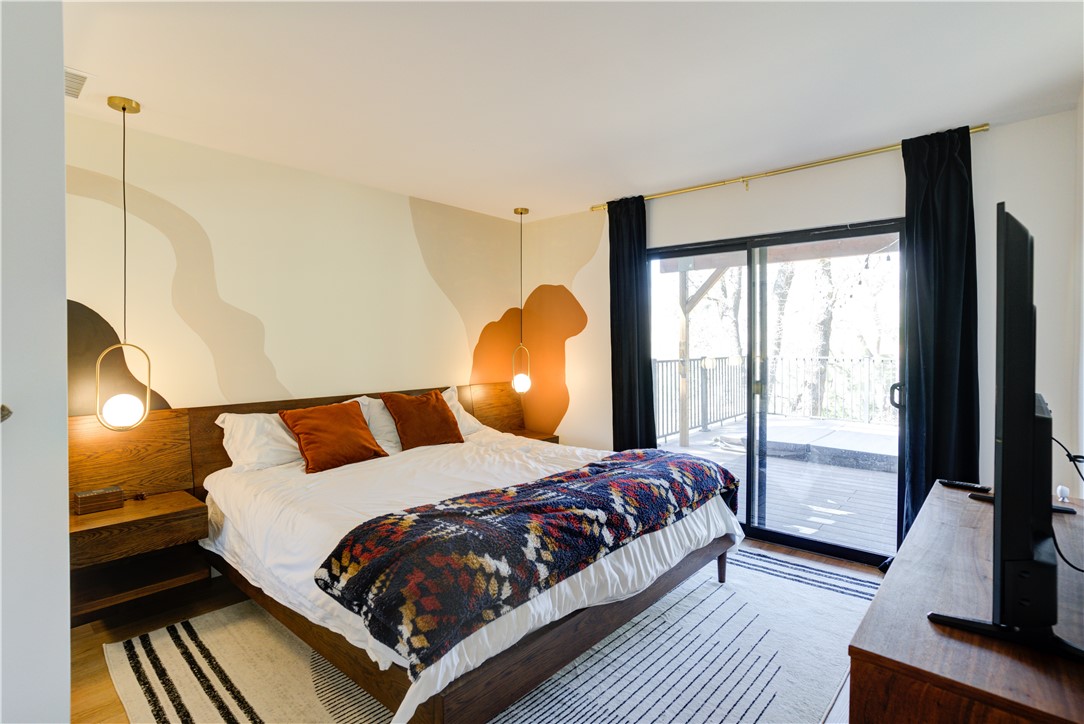 1032 Grass Valley Road Lake Arrowhead, CA 92352 - Photo 31 of 48 a bedroom with a bed and wooden floor