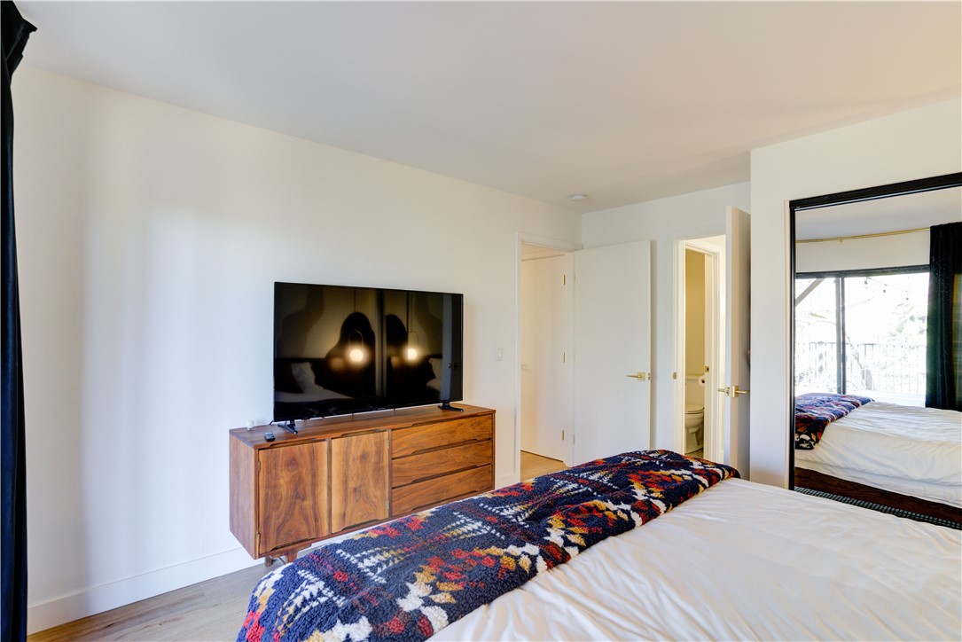 1032 Grass Valley Road Lake Arrowhead, CA 92352 - Photo 34 of 48 a bedroom with a bed and a flat screen tv