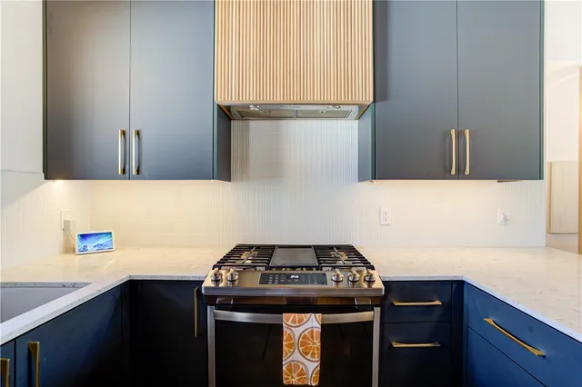 a kitchen with stainless steel appliances granite countertop a refrigerator and a sink