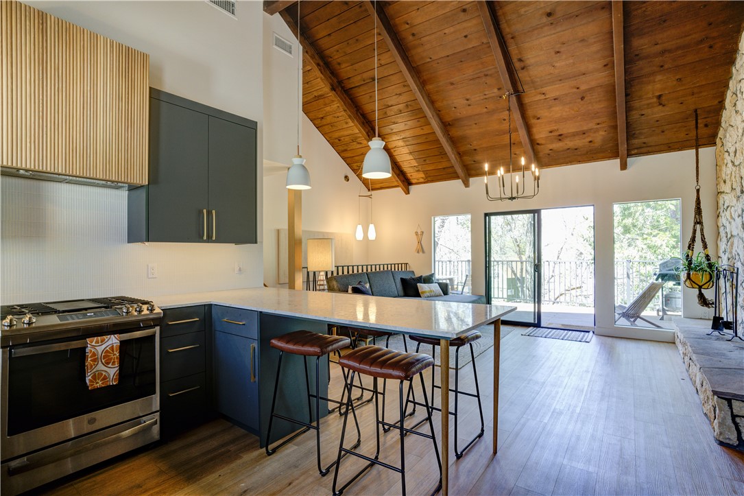 1032 Grass Valley Road Lake Arrowhead, CA 92352 - Photo 6 of 48 a kitchen with stainless steel appliances a stove a sink dishwasher and a refrigerator with wooden floor
