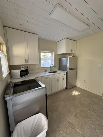 a kitchen with a cabinets and white appliances