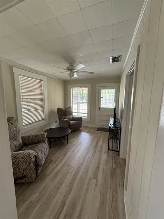 a living room with furniture and a wooden floor