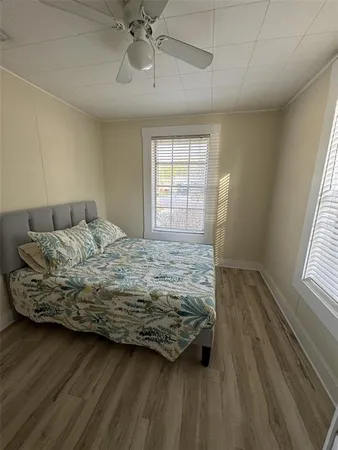 a bedroom with a bed and wooden floor