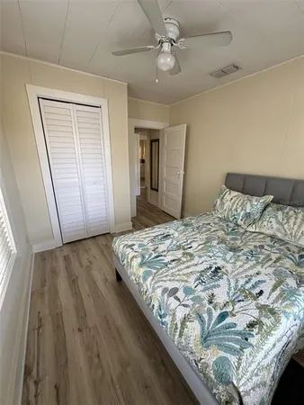 a bedroom with a bed and wooden floor
