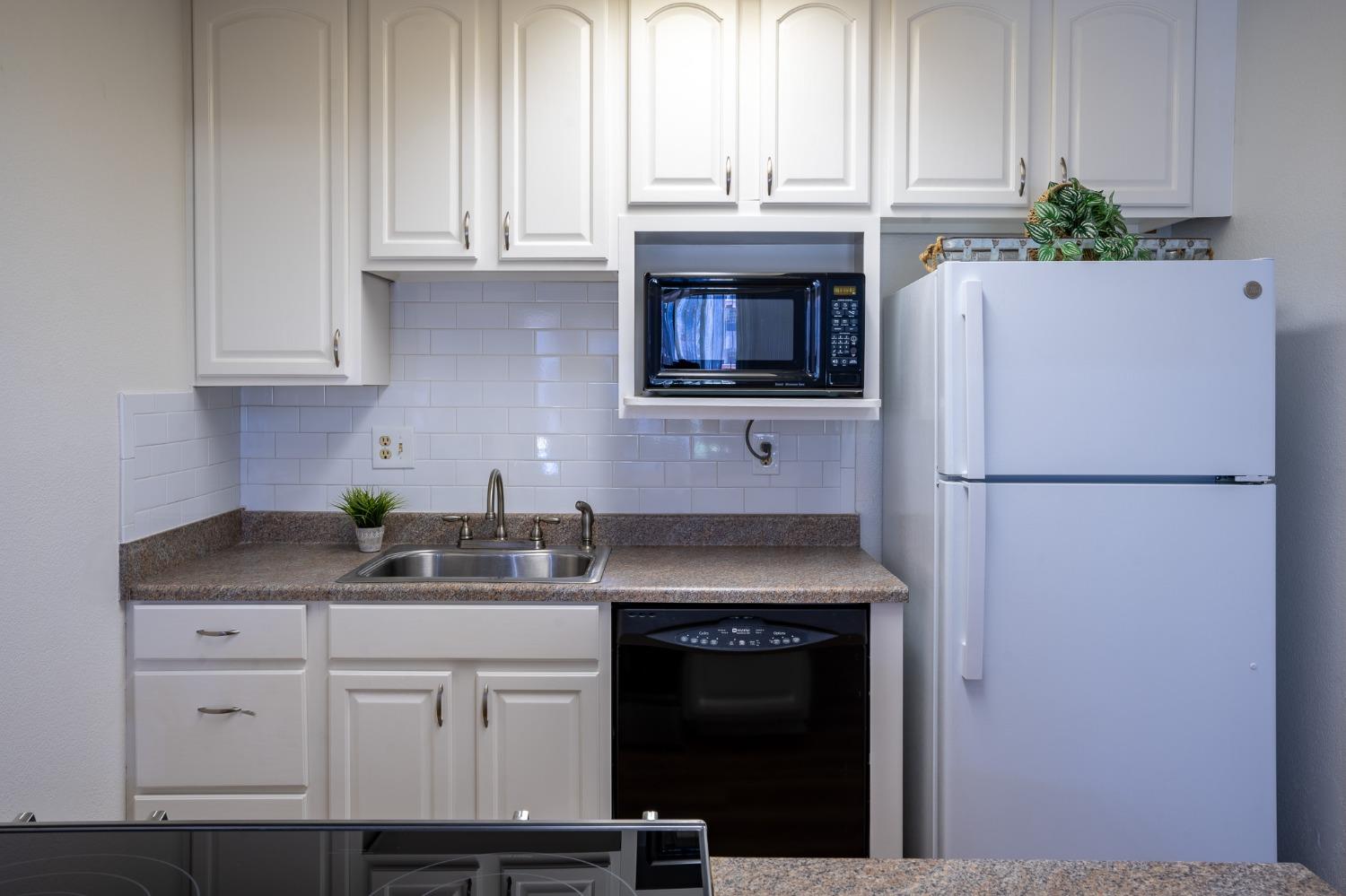 29 Dean Way Folsom, CA 95630 - Photo 9 of 17 a kitchen with stainless steel appliances granite countertop a refrigerator sink and cabinets
